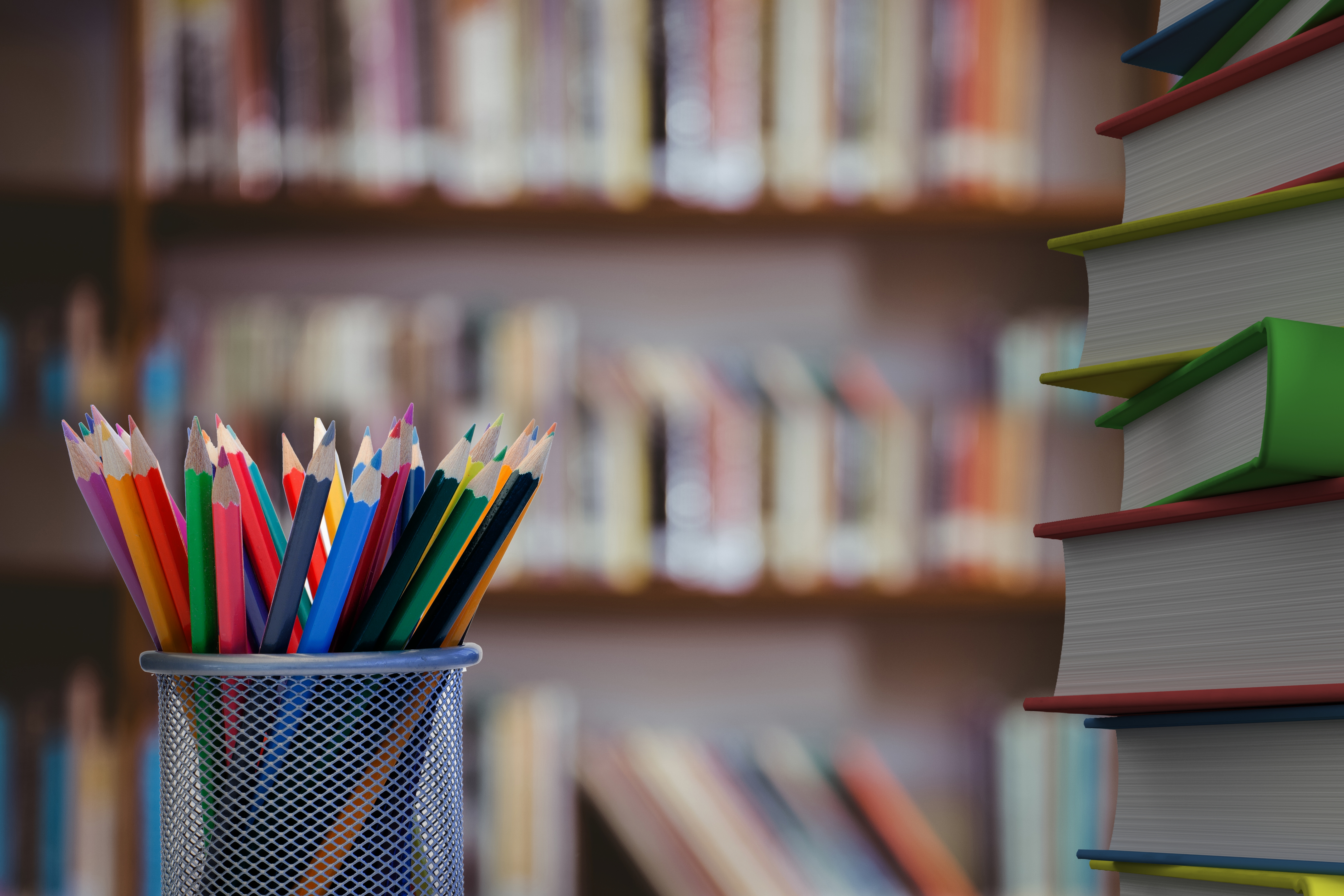 Digital composite of Pencils and stack of books with library background